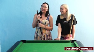 A big tits lesbian couple playing billiard and using the stick in a new way